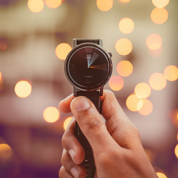 A hand holding a watch with its hands blurred because they're moving fast. A metaphor for Invouq's WordPress speed optimization service.