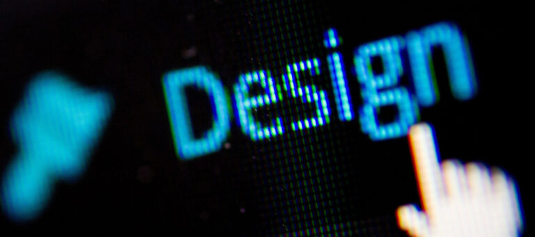 A closeup of a computer with a mouse pointer hovering over the word "design"